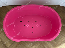 Pink plastic dog bed