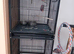 Pickle the the mustache parakeet and his cage