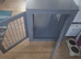 Grey dog wooden crate.